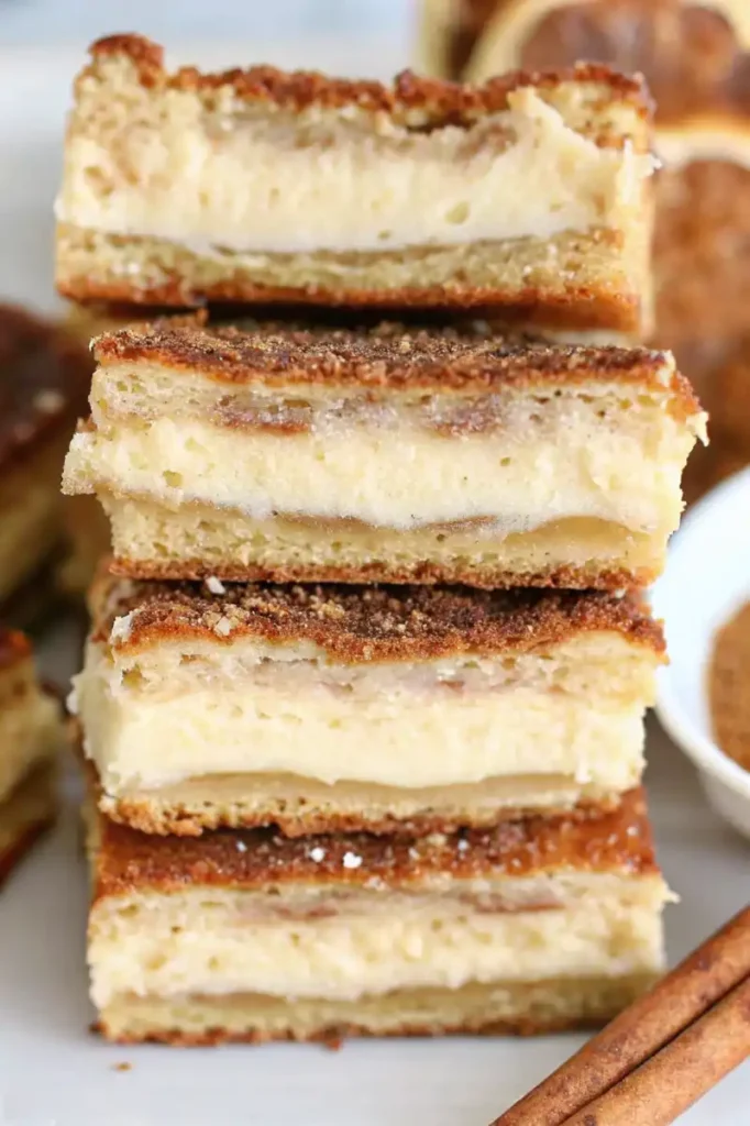 Sliced churro cheesecake bars stacked