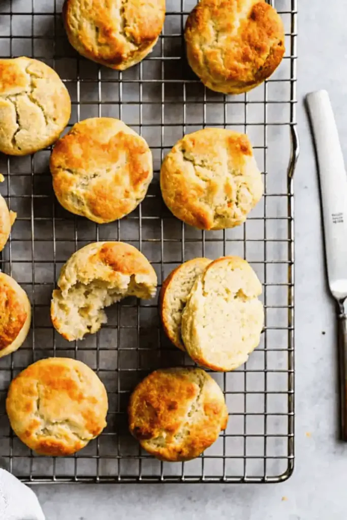 Top-down view of golden gluten-free biscuits on a cooling rack.