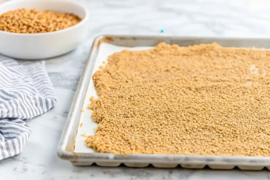 Seasoned gluten-free bread crumbs in a bowl with a spoon.