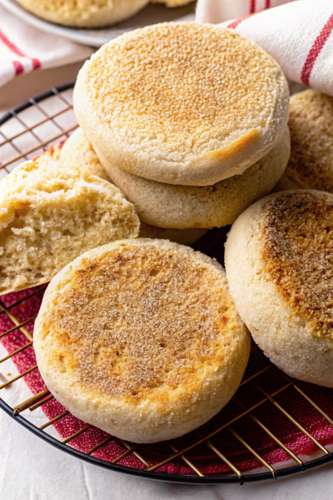 Close-up of golden gluten-free muffins on a plate with airy interiors.